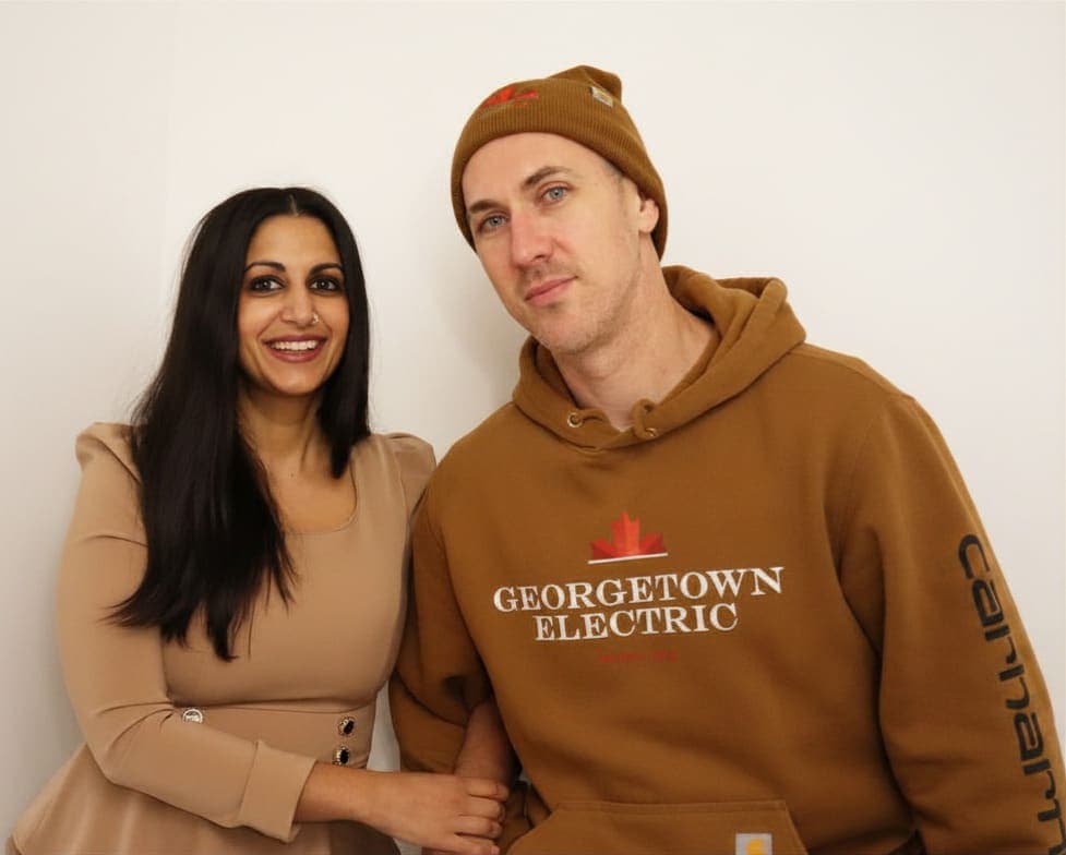 Georgetown Electric crew member in branded gear with a smiling customer