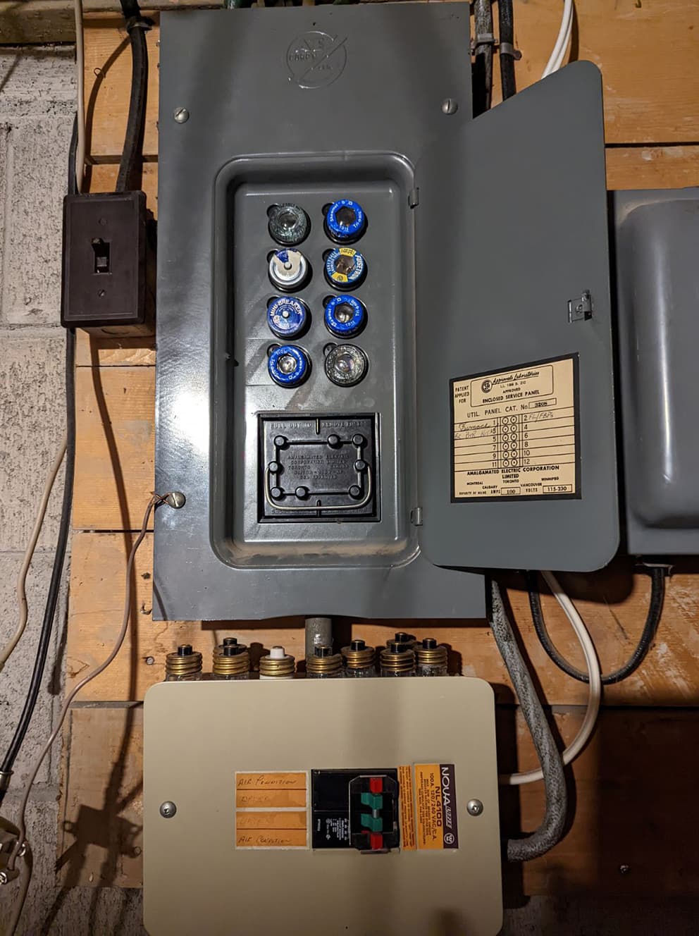 Original fuse panel with screw-in fuses before replacement