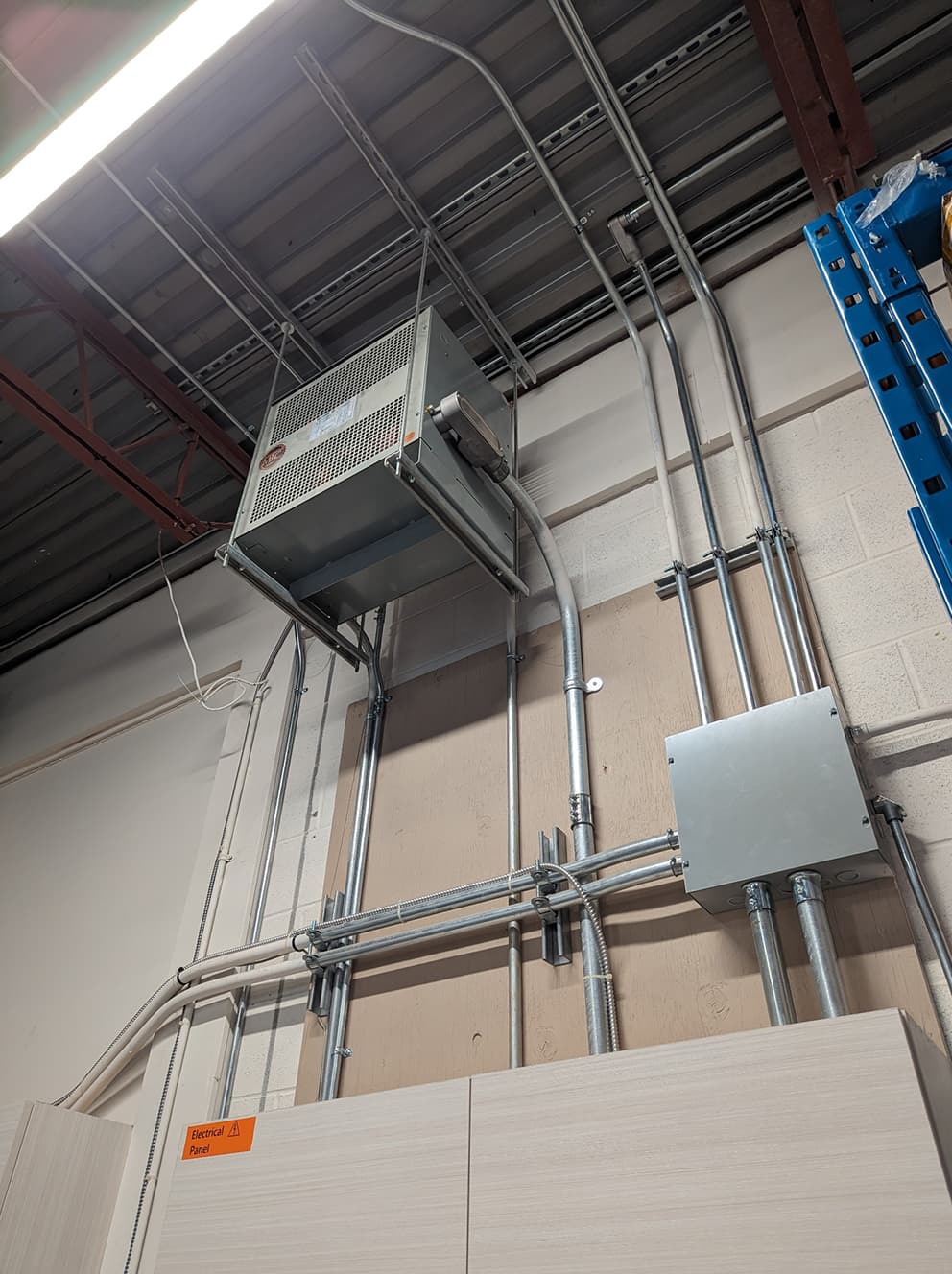 Commercial conduit and transformer installation in a warehouse