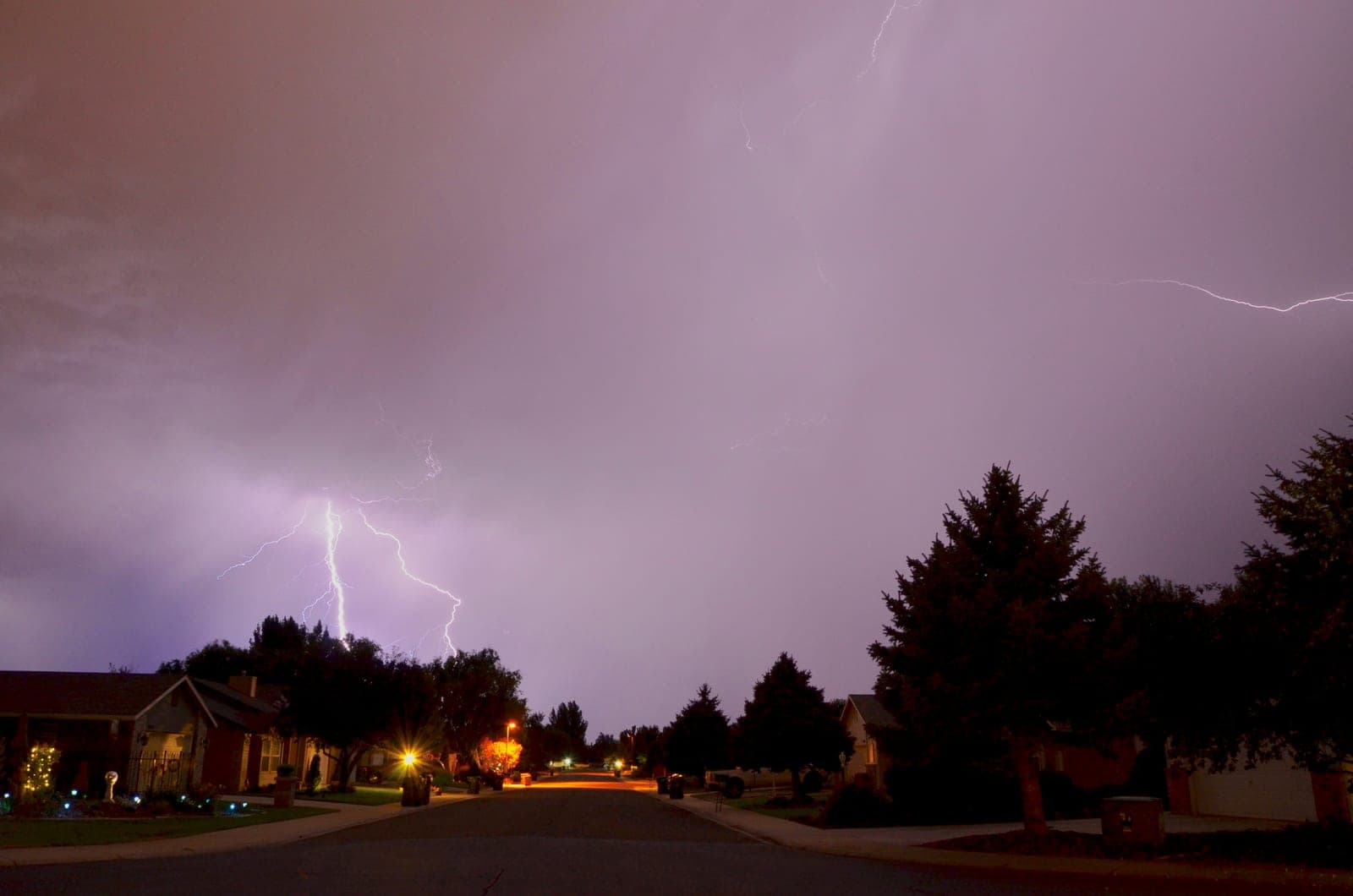 Lightning over a residential street at night