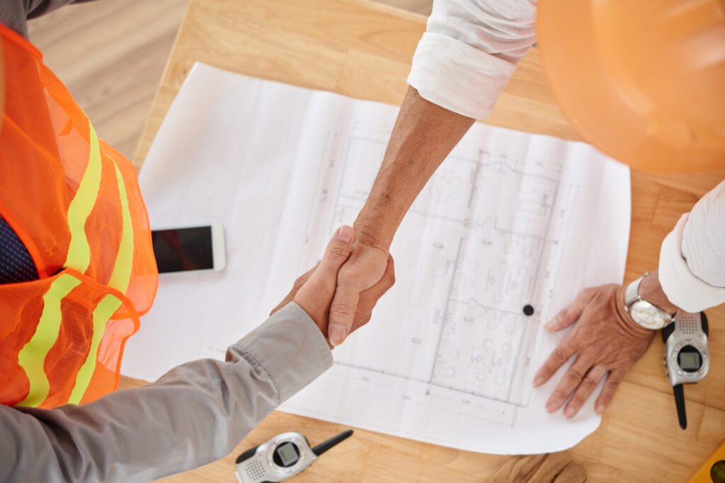 Firm handshake of contractor and head engineer